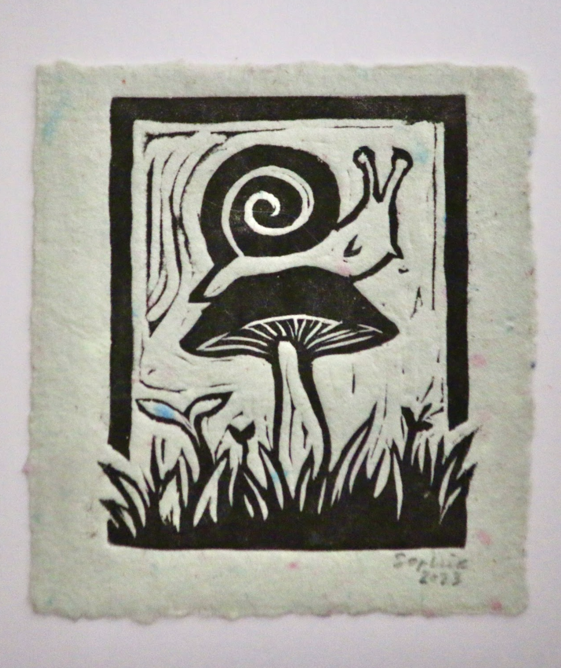 linocut of snail on a mushroom
